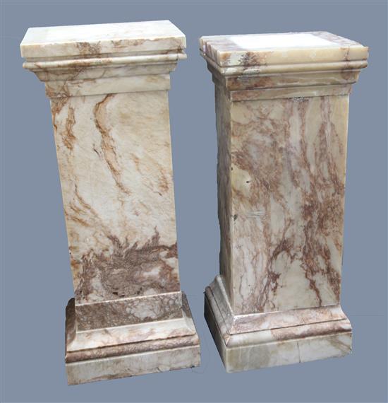 A near pair of square section pink veined marble pedestals, W.1ft 6in. D.1ft 4in. H.3ft 8in.